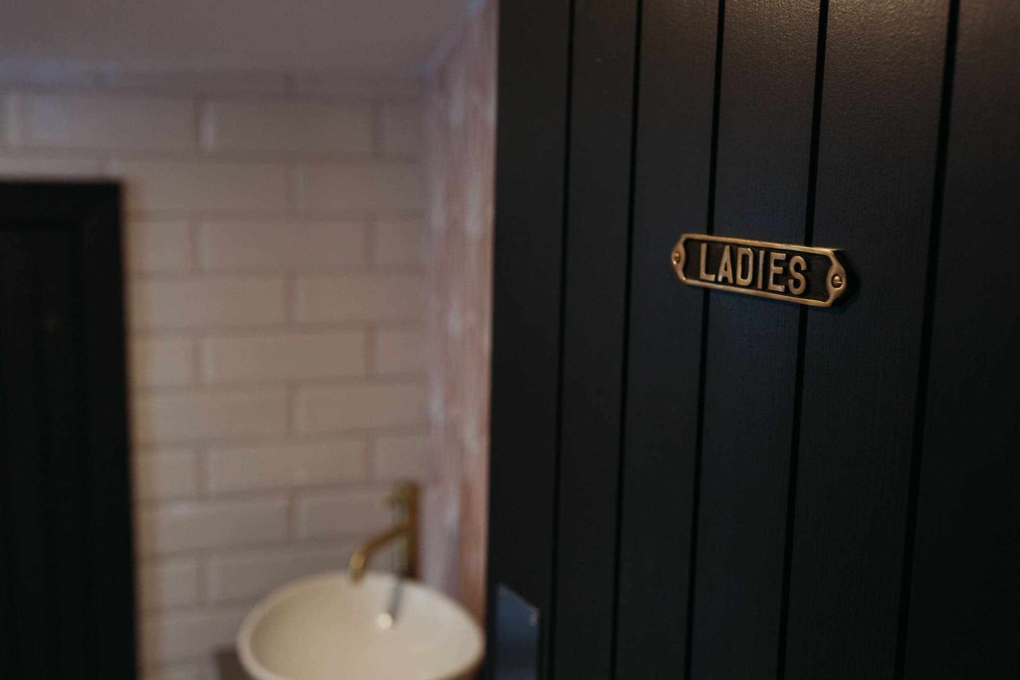 The corridor to the function room, with a brass Ladies sign on the door