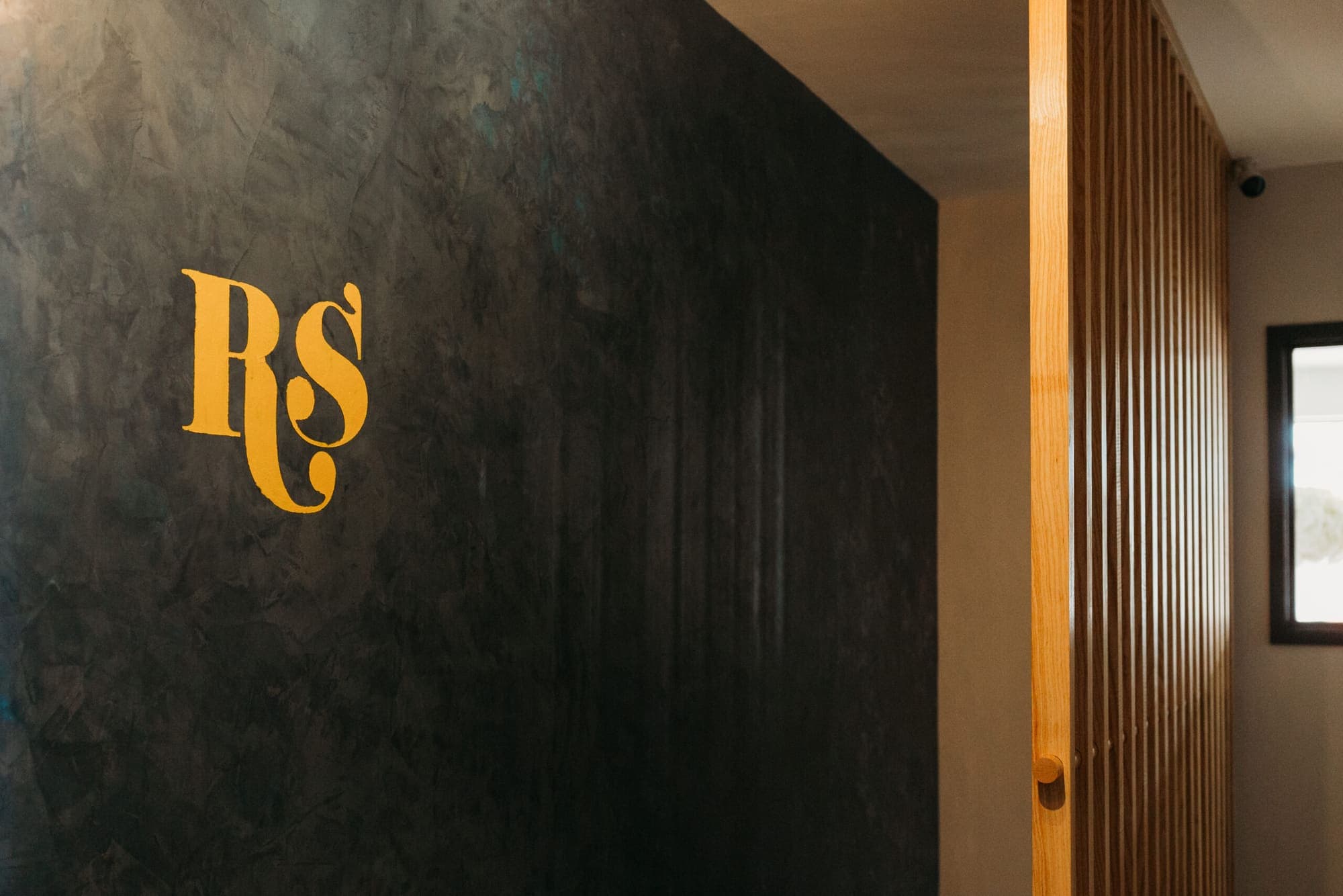 The venue monogram painted large on the function room wall