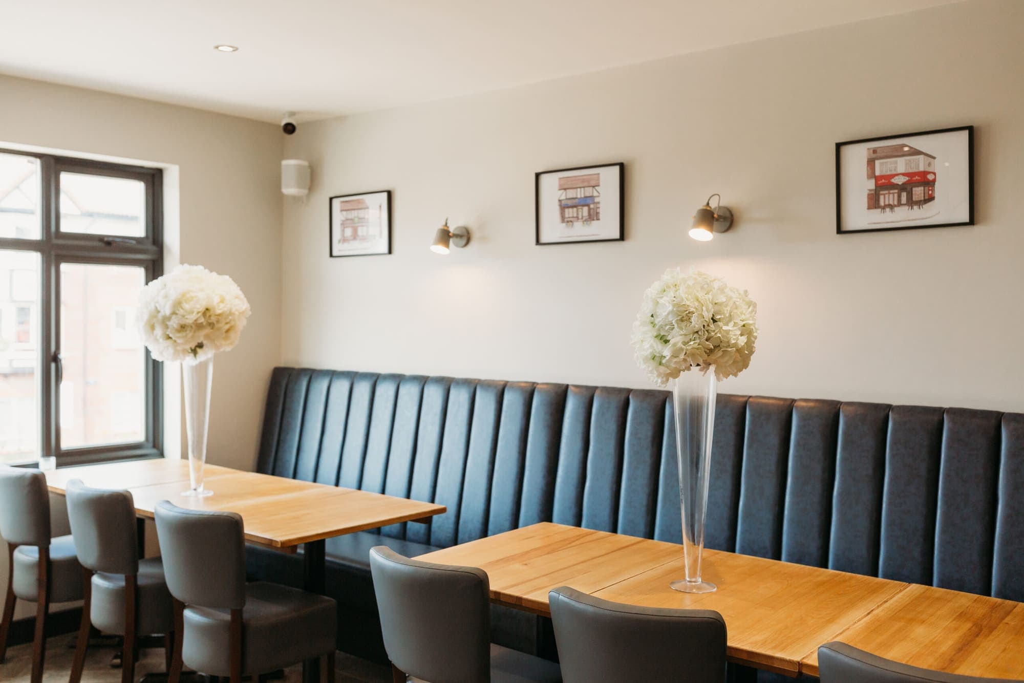 Banquette seating and set tables in the private function room