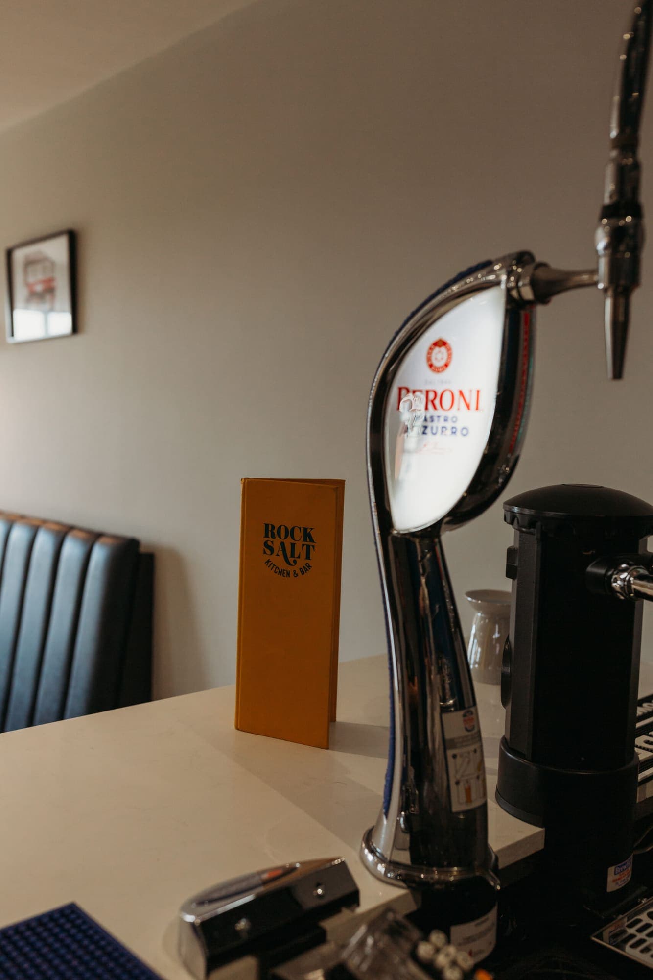 A beer tap and glassware on the upstairs bar