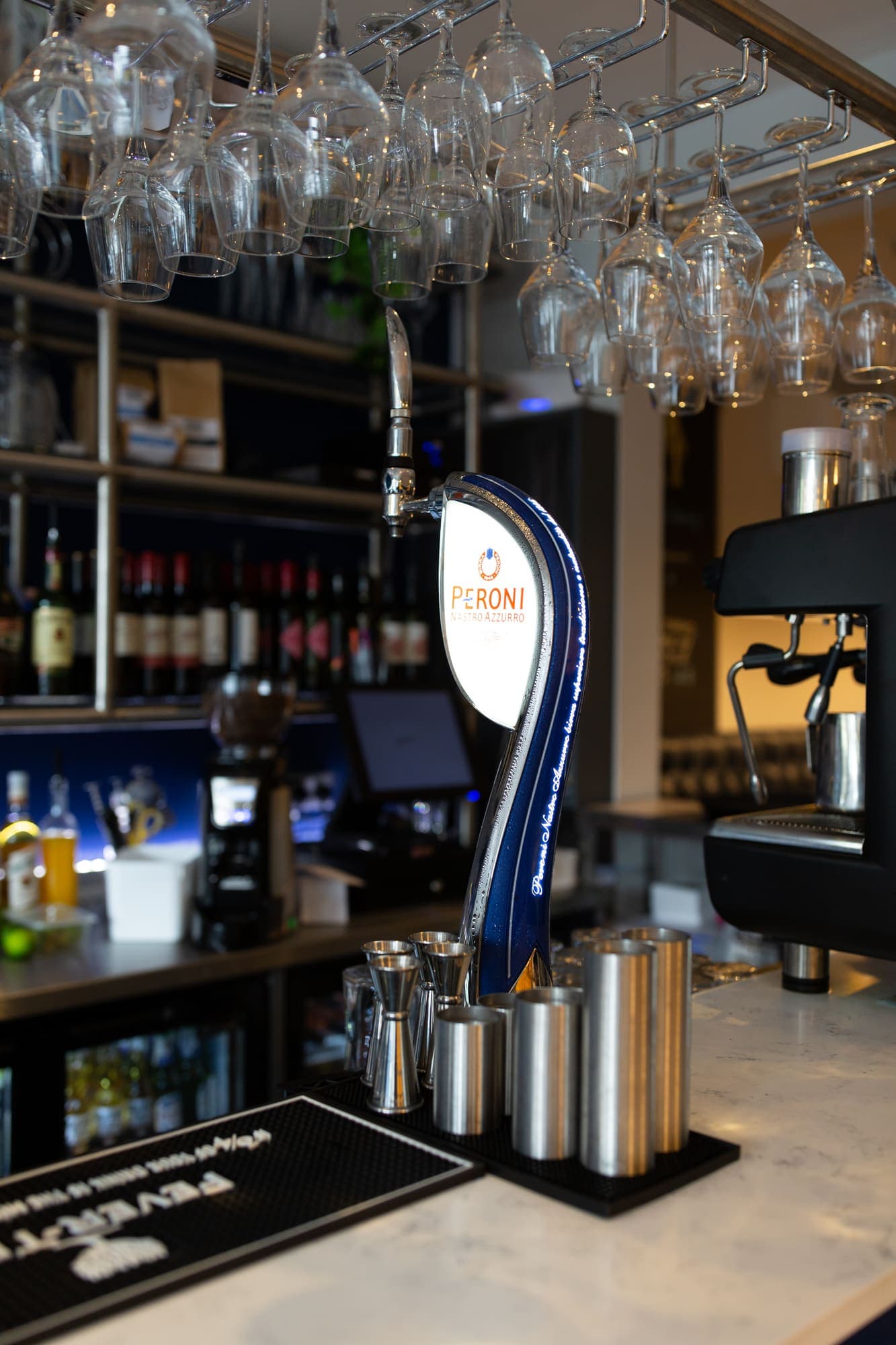 Bottles and glassware stacked on the back bar shelving