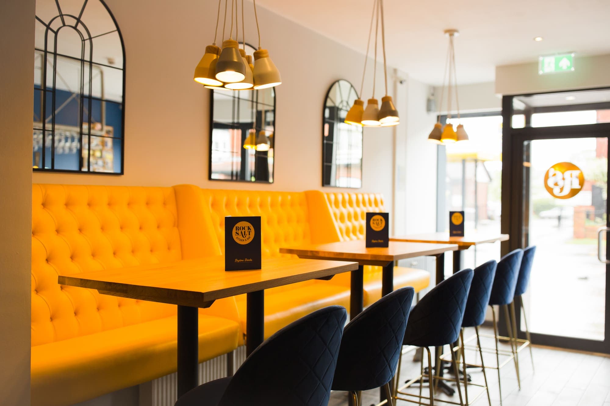 Velvet banquette seating running along the dining room wall