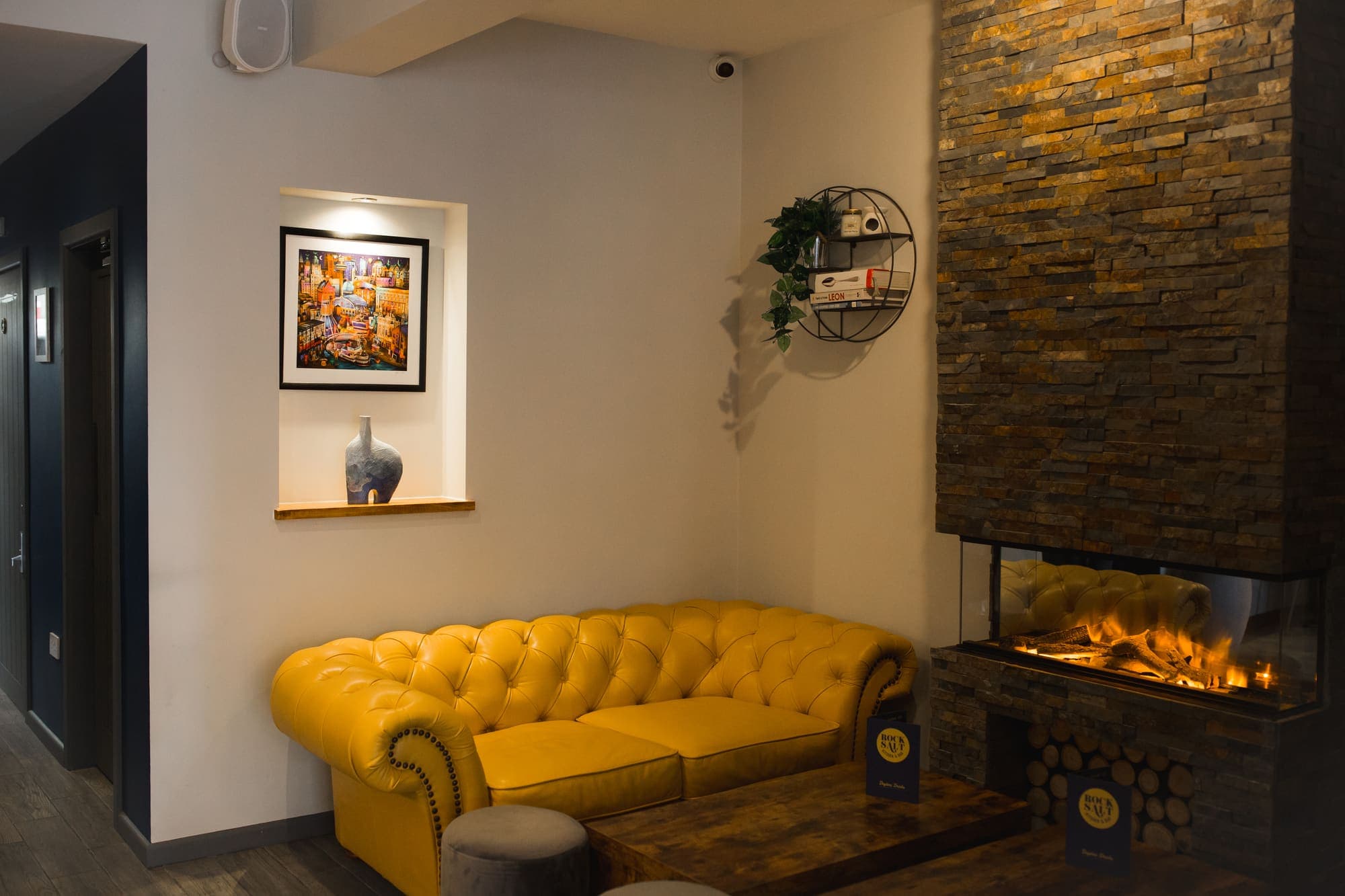 A buttoned chesterfield sofa in the corner of the lounge