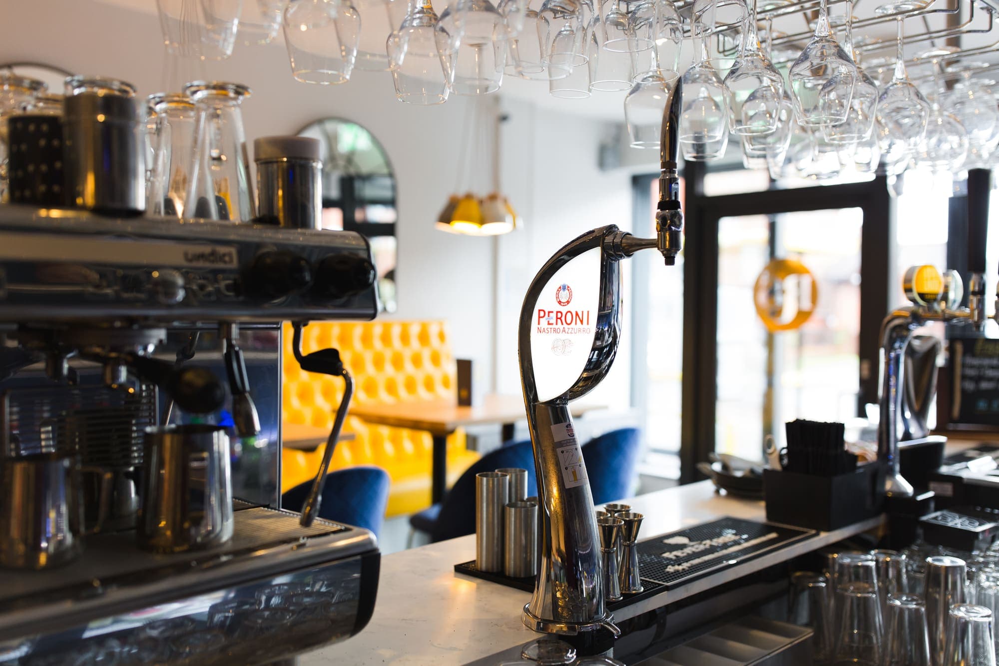 The espresso machine and coffee station behind the bar