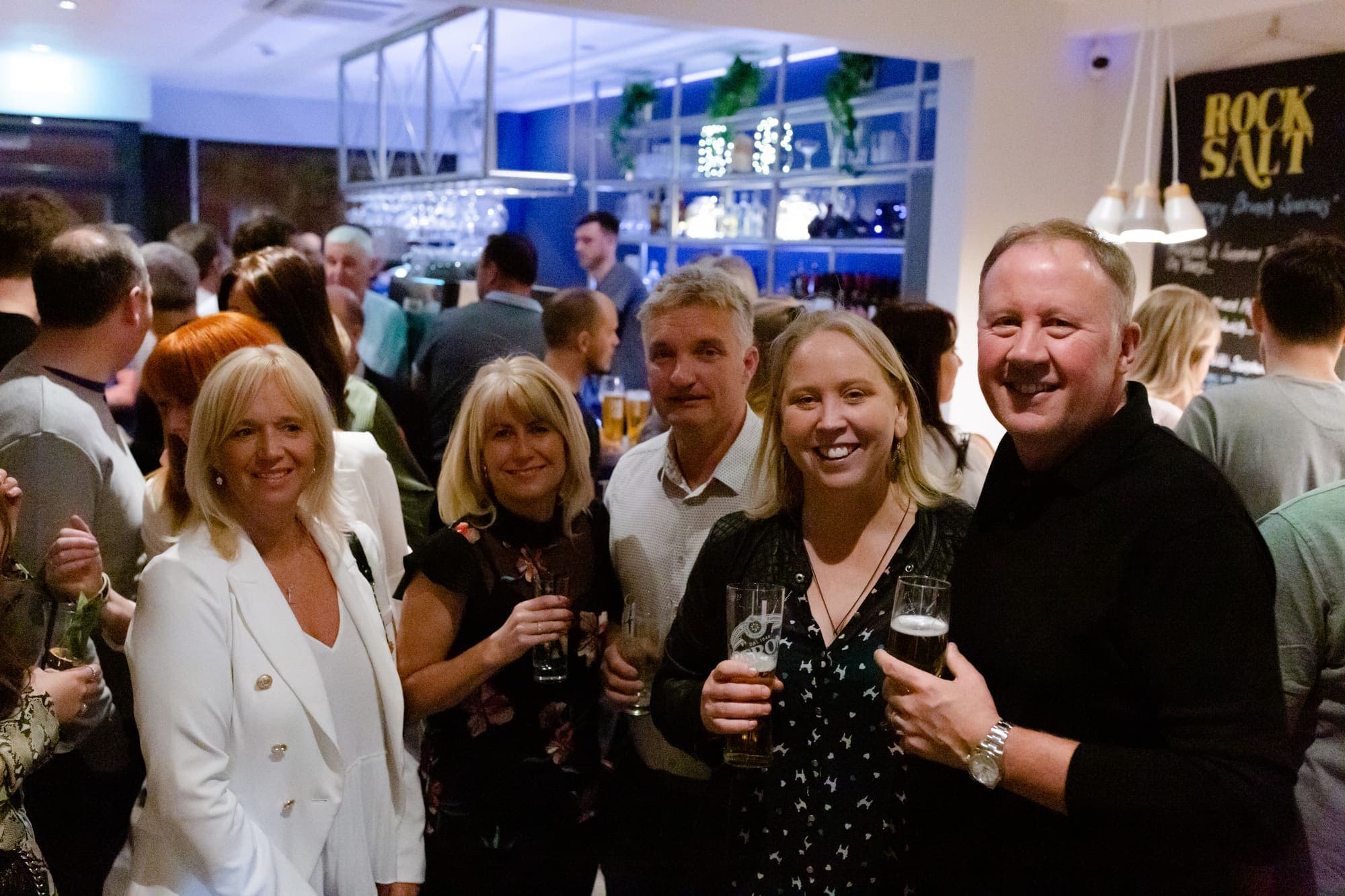A group of guests raising their glasses in the bar