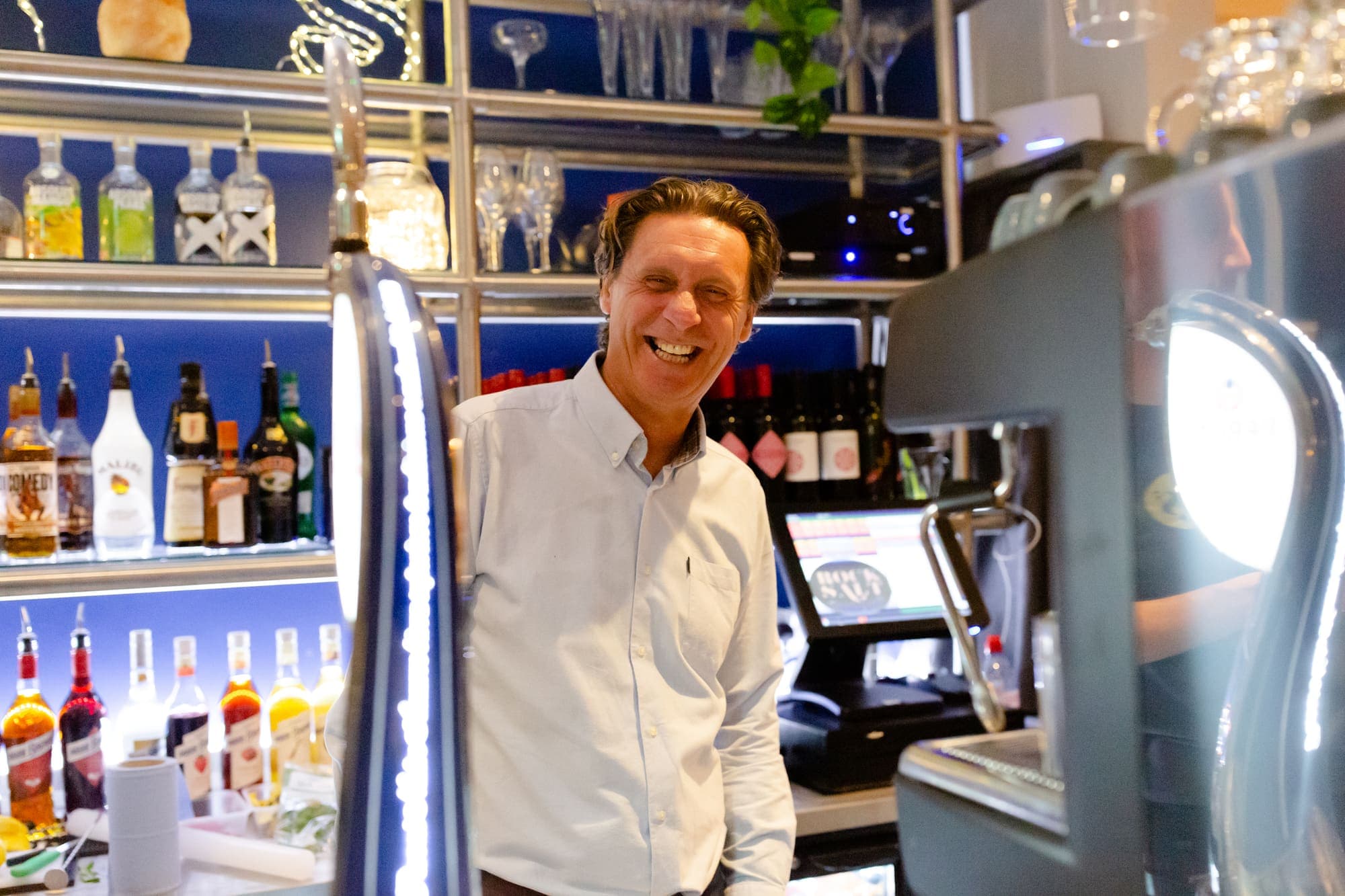 A host standing at the bar