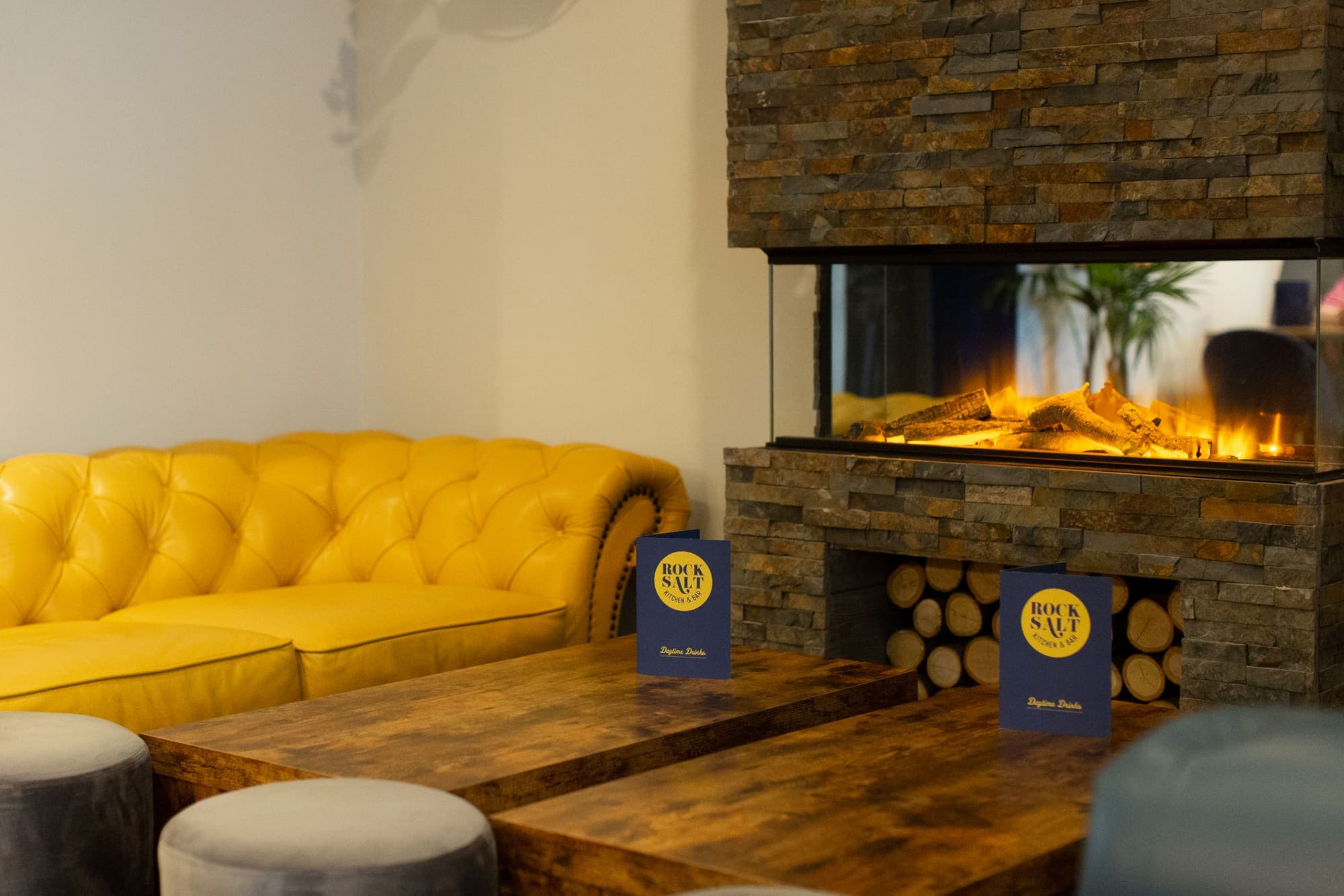 Lounge seating and pendant lighting in the front of the room