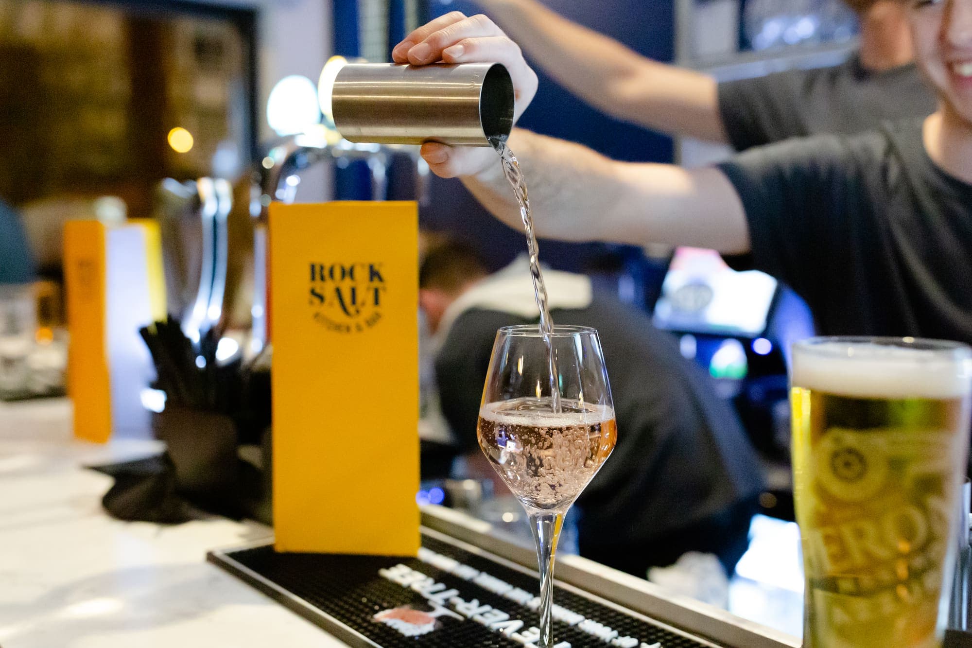 Rosé being poured into a wine glass at the bar