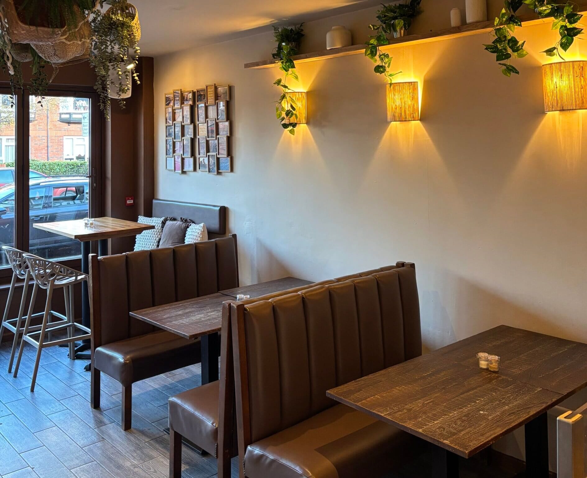 Leather booth seating and dark wood tables under warm wall lights